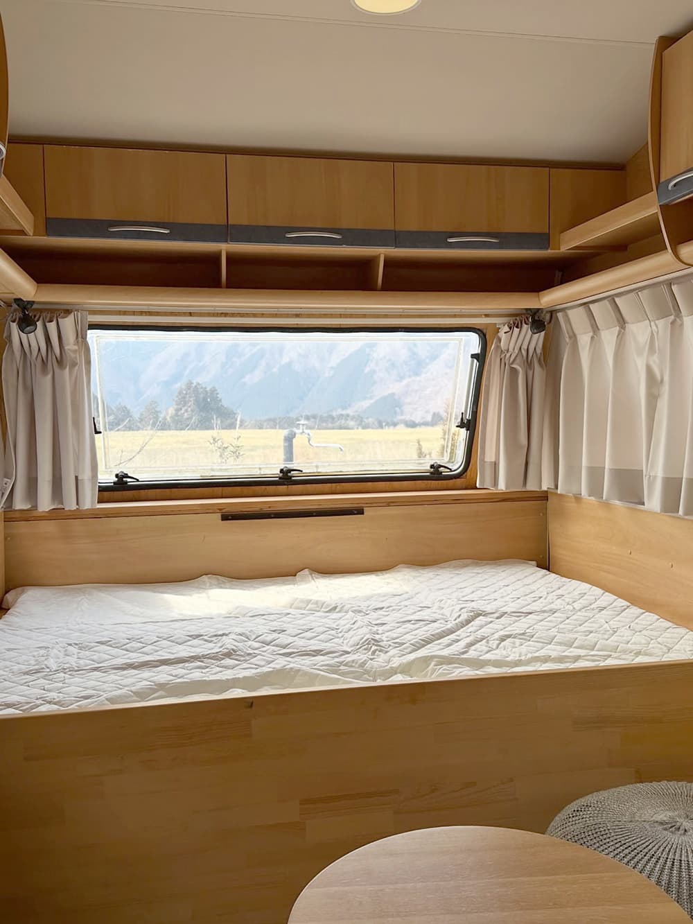 富士山が見えるキャンプ場の富士宮市アーバンキャンピング朝霧宝山のトレーラーハウスサイトの中のベッド